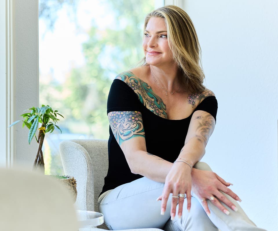 woman in a black shirt sitting down