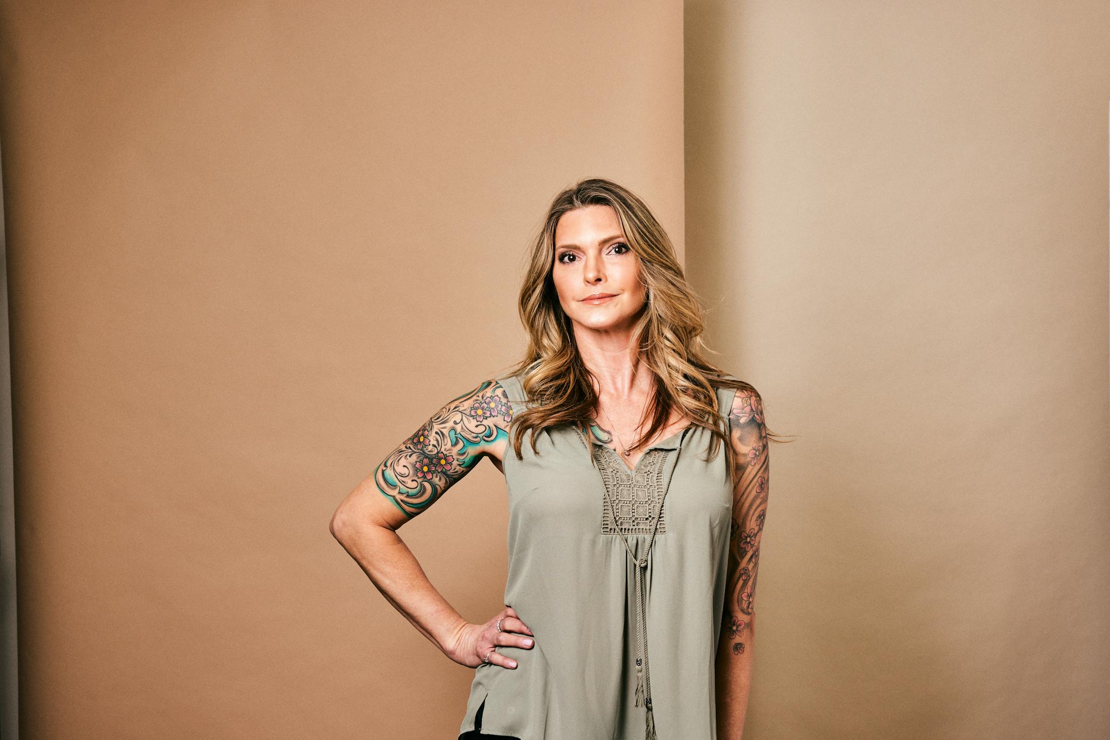 Woman in a green shirt with her hand on her hip